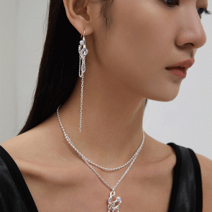 a Sterling silver double chain necklace with a pearl pendant