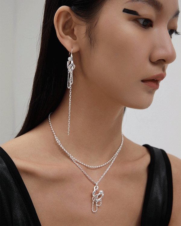 a Sterling silver double chain necklace with a pearl pendant